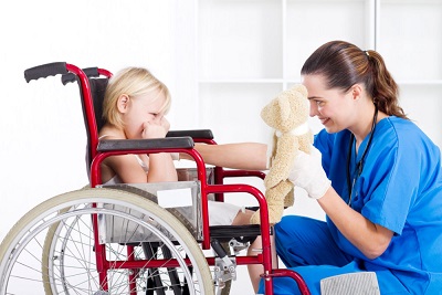 nurse giving a stuff toy to the young girl