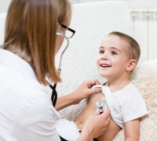 Nurse doing check up of the young boy