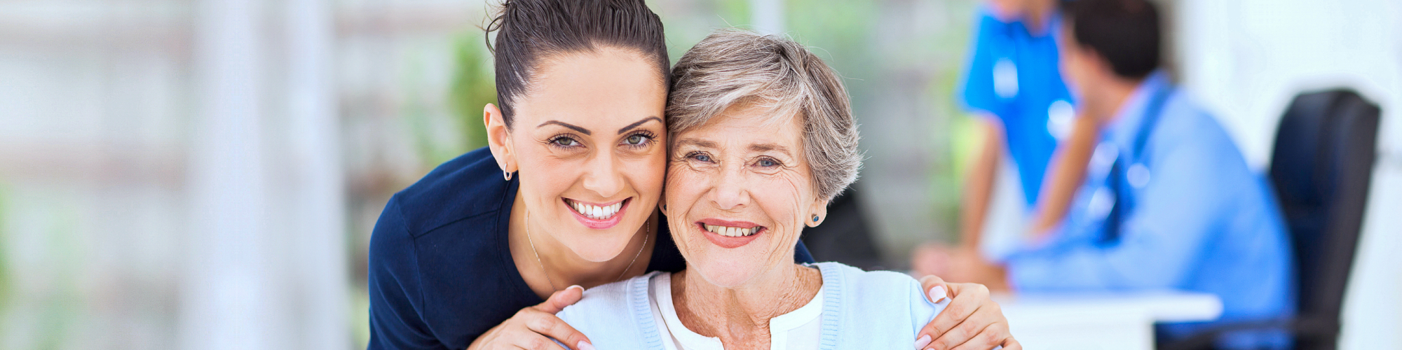 Senior woman and caregiver smiling together